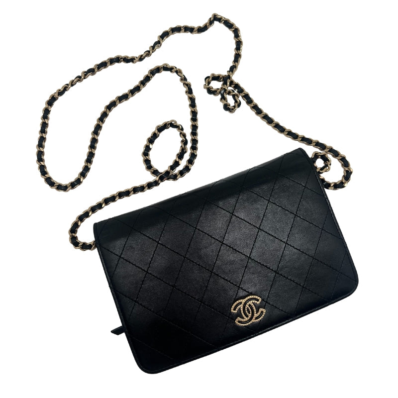 Chanel Quilted Chain Wallet  Black Leather Exterior  Gold Toned Hardware   Chanel Monogram Emblem   Single Should Strap   Front Flap Closure with Button  Black Leather Interior   Interior Flat Pocket Attached to Front Flap with Zip Closure  Single Flat Pocket Under Front Flap  Interior Pocket with Zip Closure   Six Interior Card Pockets 
