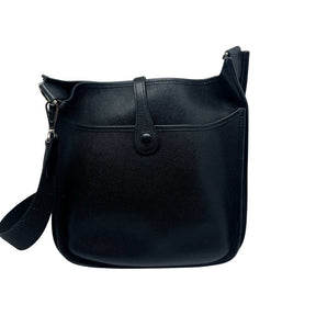 Hermès Evelyne PM Shoulder Bag  Black Leather Exterior   Silver Toned Hardware   Hermès Logo on Front Exterior   Single Fabric Cross Body Strap  Single Exterior Flat Back Pocket  Button Closure on Exterior   Black Suede Interior 