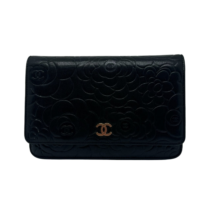 Chanel Lambskin Camellia Embossed Wallet on Chain WOC  Black Leather Exterior   Gold Toned Hardware  Flower Embellishments with Chanel Logo on Exterior   Single Chain Strap   Chanel Emblem on Exterior   Frontal Exterior Flap with Button Closure   Two Interior Zipper Pockets  Single Interior Flat Pocket with Black Leather Exterior   Eight Small Flat Interior Pocket   Single Interior Pocket   Cream Fabric Interior 