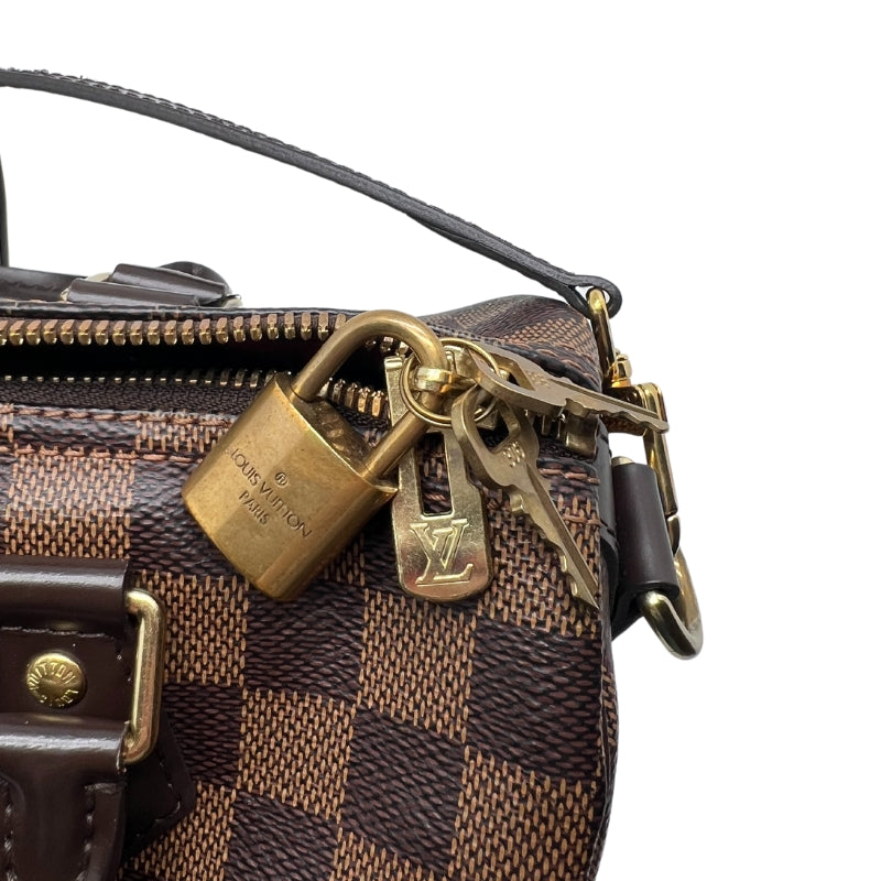 Louis Vuitton Speedy Bandoulière MM  Damier Canvas Exterior   Gold Toned Hardware  Double Brown Leather Handles  Single Removable and Adjustable Shoulder Strap   Zip Closure with Lock and Key   Red Fabric Interior   Single Interior Flat Pocket with Zip Closure 