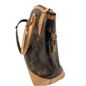 Louis Vuitton Monogram Lockit Horizontal Bag  Monogram Canvas Exterior   Gold Toned Hardware   Removable Flat Strap with Rest Attached   Double Exterior Shoulder Straps  Lock Detailing Attached to Exterior   Single Exterior Zip Closure   Brown Fabric Interior   Double Interior Flat Pockets