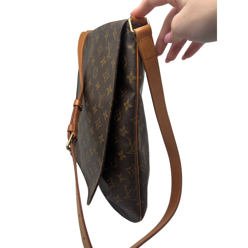 Louis Vuitton Musette Bag  Monogram Canvas Exterior   Gold Toned Hardware   Single Flat Adjustable Crossbody Strap   Fold Over Flap Closure With Brown Canvas Interior   Tan Suede Interior   Two Interior Flat Pockets 