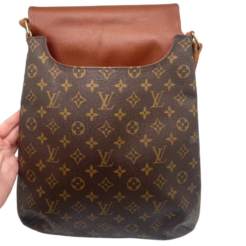 Louis Vuitton Musette Bag  Monogram Canvas Exterior   Gold Toned Hardware   Single Flat Adjustable Crossbody Strap   Fold Over Flap Closure With Brown Canvas Interior   Tan Suede Interior   Two Interior Flat Pockets 