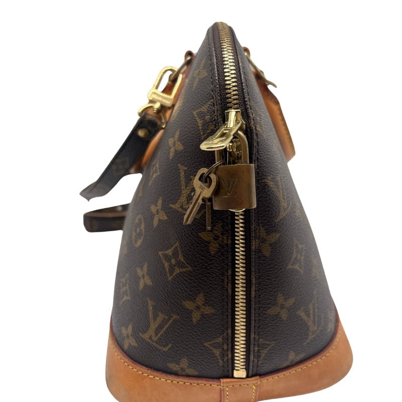 Louis Vuitton Alma MM Bag Monogram Canvas Exterior   Gold Toned Hardware  Double Leather Handles   Removable and Adjustable Crossbody Strap  Lock and Key Detailing on Exterior Zipper  Brown Leather Exterior Base  Exterior Zip Closure   Brown Fabric Interior   Single Interior Flat Pocket 