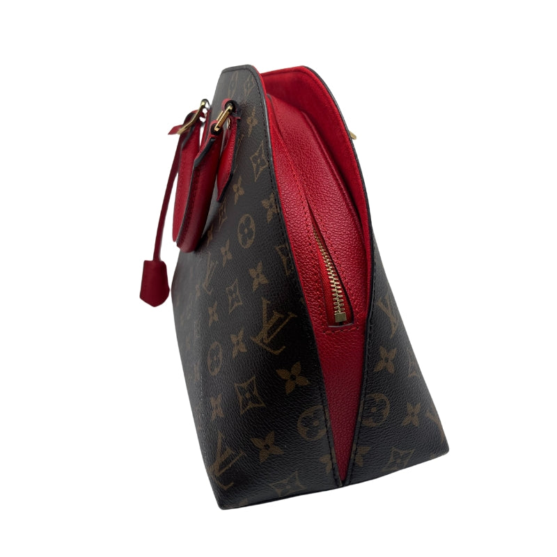 Louis Vuitton BNB Alma Monogram Bag  Monogram Canvas Exterior   Gold Toned Hardware  Double Rounded Red Leather Straps   Removable Flat Red Shoulder Strap  Red Tag Accent on Exterior   Single Zip Closure   Red Leather Exterior Surrounding Zipper   Red Suede Interior   Single Interior Flat Pocket 