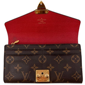 Louis Vuitton Monogram Leather Pallas Wallet, LV logo print exterior, red leather exterior flap, gold tone hardware, push lock closure at front, red leather interior, four interior pockets and card slots, condition excellent, top view