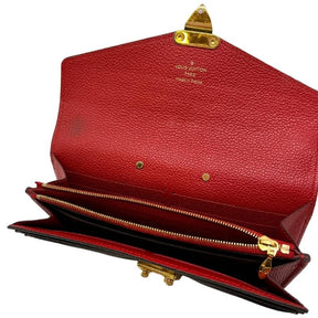 Louis Vuitton Monogram Leather Pallas Wallet, LV logo print exterior, red leather exterior flap, gold tone hardware, push lock closure at front, red leather interior, four interior pockets and card slots, condition excellent, top view
