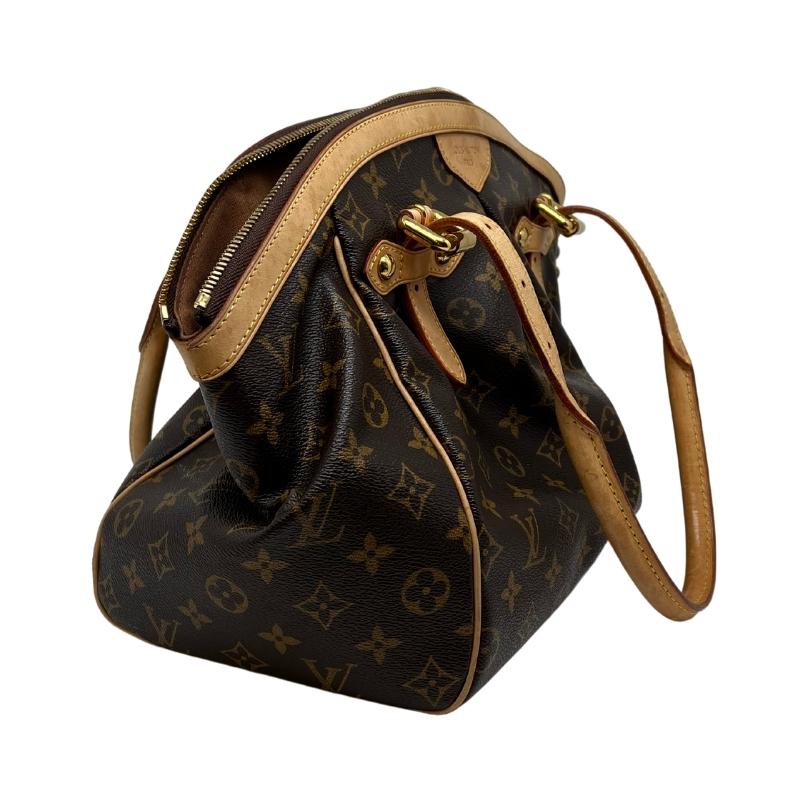 Louis Vuitton Trivoli GM with brown mongram coated canvas, leather trim embellishment, dual shoulder straps, and protective feet at base. Good condition