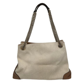 Gucci canvas soho chain tote, beige canvas exterior, chain dual shoulder strap, brown leather embellishments, brown leather tassel, silver tone hardware, GG logo stitched on front, canvas lining, three interior pockets, top clasp closure, condition good, back view